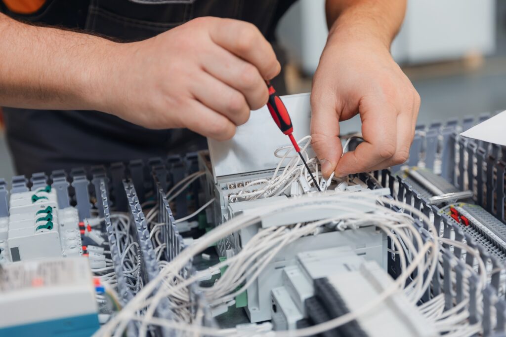 Technician,Assembling,Electrical,Components,In,Industrial,Factory.